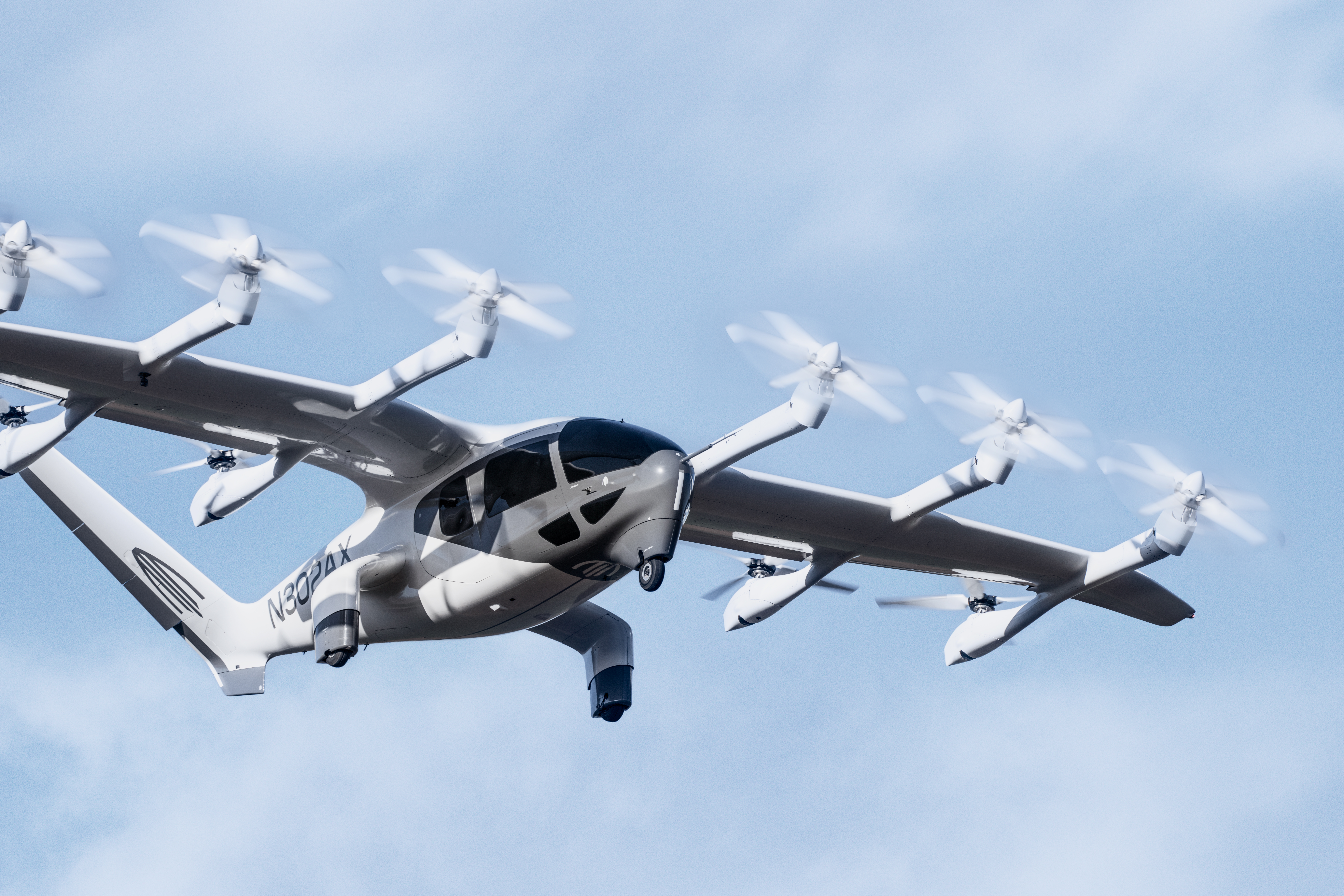 Archer's eVTOL aircraft flying through a clear blue sky.